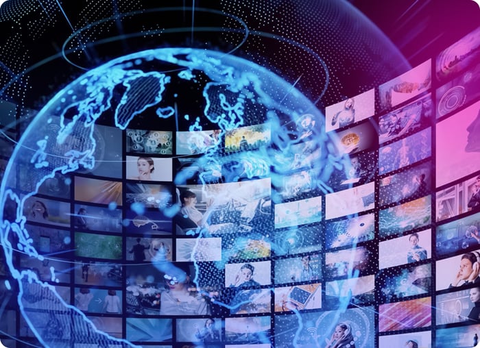 Illuminated globe surrounded by a wall of news screens